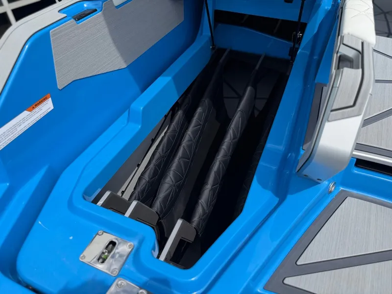 Slide: The Image of 2026 Nautique Super Air G25 Paragon storage compartment in blue. - 14