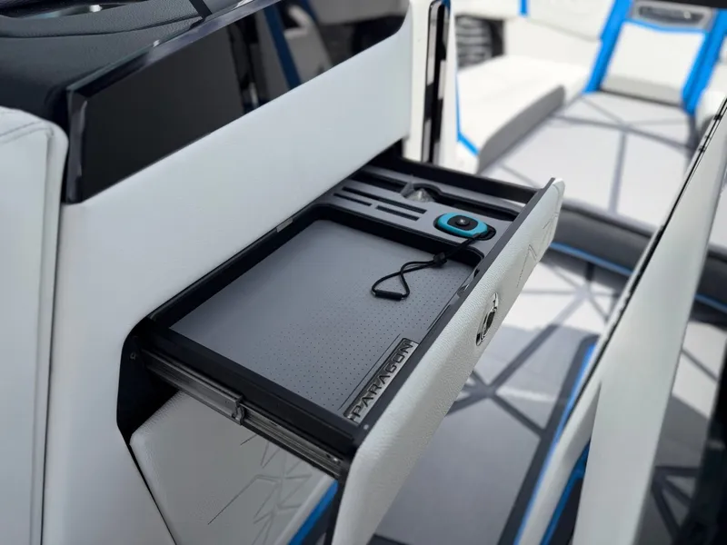 Slide: The Image of 2026 Nautique Super Air G25 Paragon interior with storage compartment. - 27