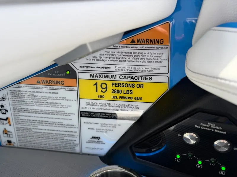 Slide: The Image of Warning labels and capacity sign on Nautique Super Air Nautique G25 Paragon 2026. - 30