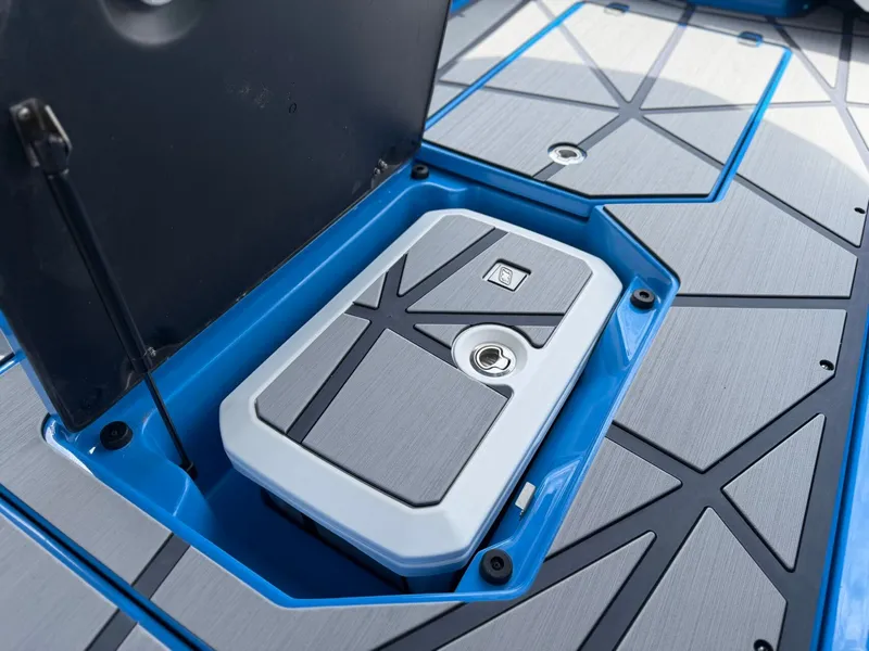 Slide: The Image of 2026 Nautique Super Air G25 Paragon storage compartment open. - 34