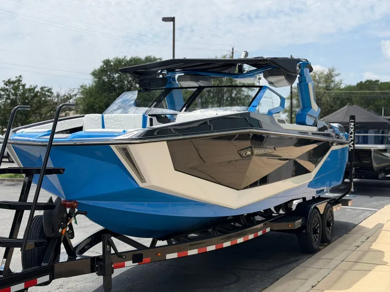 Slide: The Image of 2026 Nautique Super Air Nautique G25 Paragon on trailer, blue design. - 6