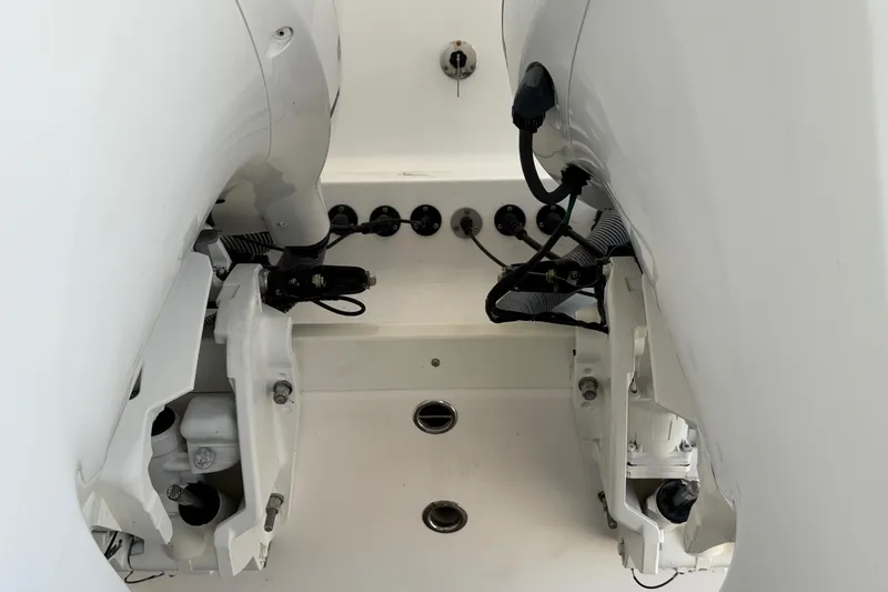 Slide: The Image of 2017 Everglades 255 Center Console boat engine compartment, showcasing dual outboard motors. - 19