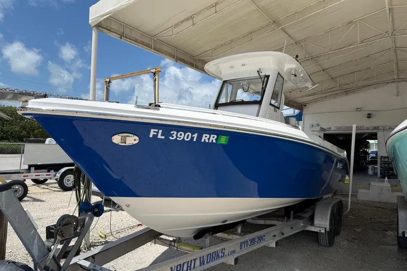 Slide: The Image of 2017 Everglades 255 Center Console boat on trailer in marina setting. - 2