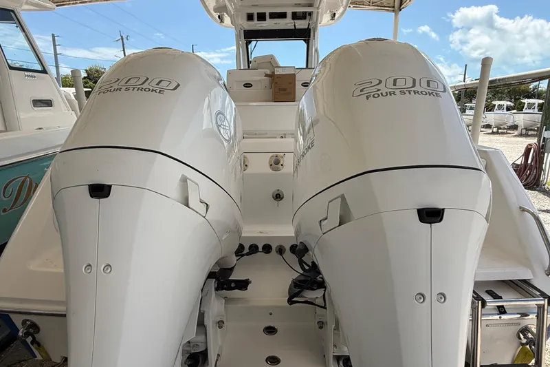 Slide: The Image of 2017 Everglades 255 Center Console with twin 200 Four Stroke engines, docked outdoors. - 20