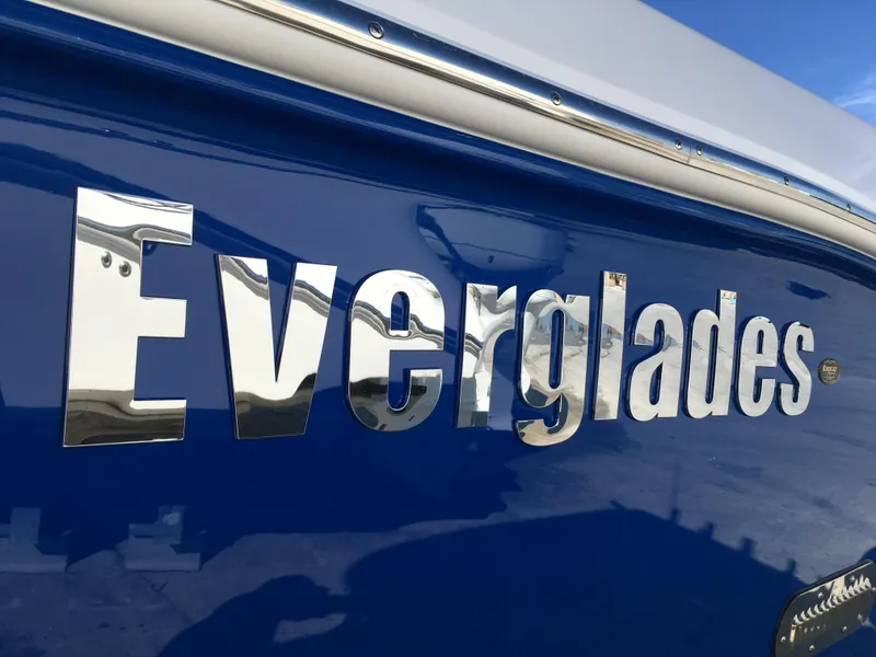 Slide: The Image of Everglades 255 Center Console boat, shiny logo on blue background. - 5