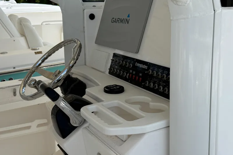Slide: The Image of 2017 Everglades 255 Center Console helm with Garmin display and steering wheel. - 9