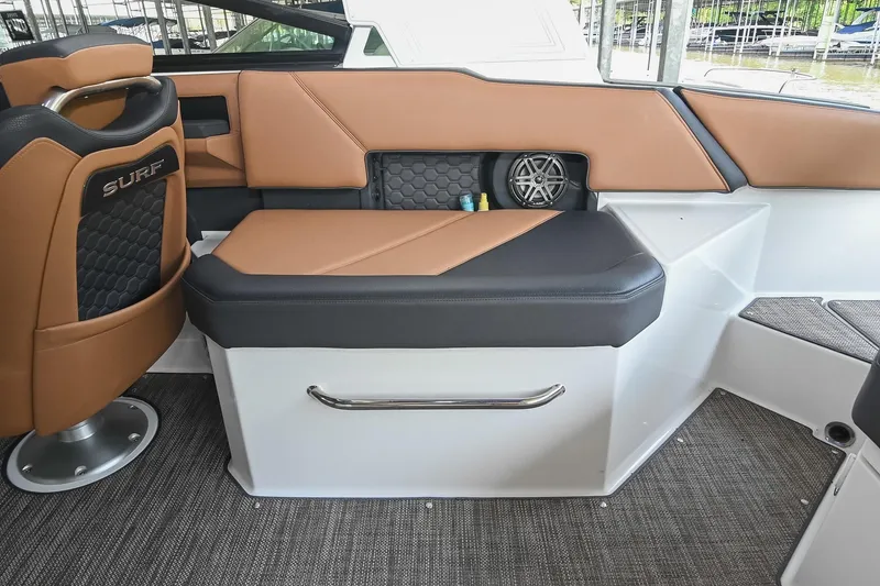 Slide: The Image of 2022 Cobalt R6 Surf boat interior with tan and black seating, featuring stylish design elements. - 14