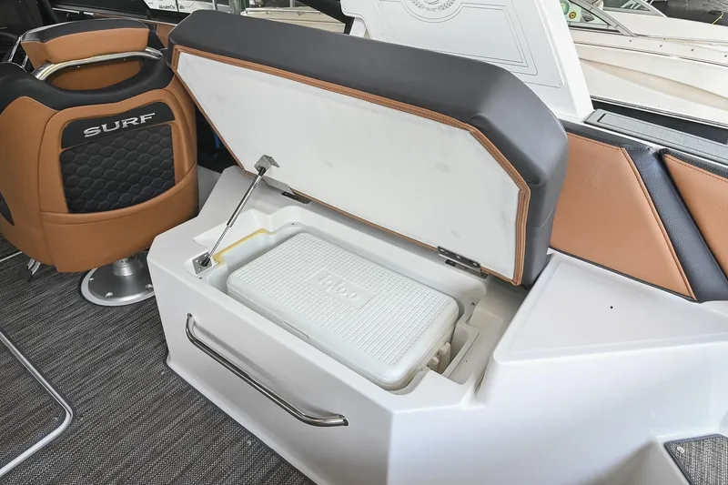 Slide: The Image of 2022 Cobalt R6 Surf boat interior with storage compartment and Igloo cooler. - 15