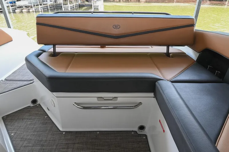 Slide: The Image of 2022 Cobalt R6 Surf boat interior with tan and black seating. - 17