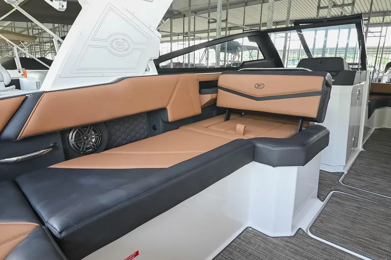 Slide: The Image of 2022 Cobalt R6 Surf boat interior with luxurious tan and black seating. - 18