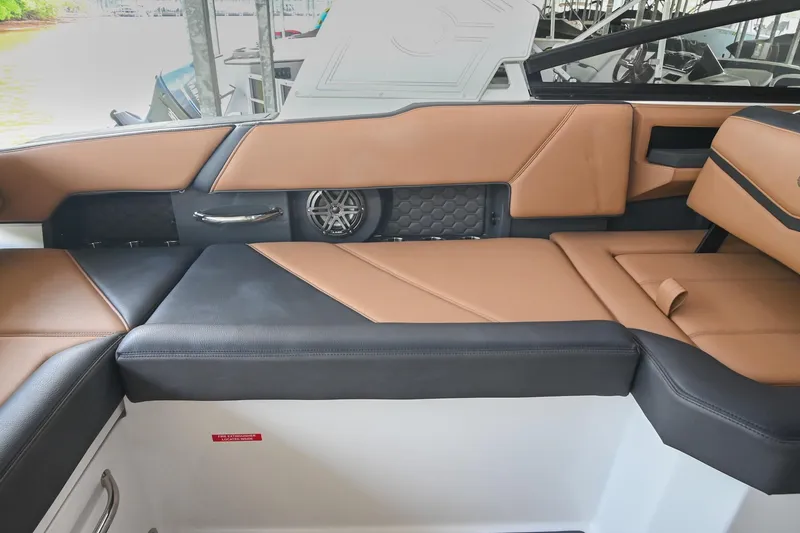 Slide: The Image of Luxurious interior seating of 2022 Cobalt R6 Surf boat with tan and black upholstery. - 19