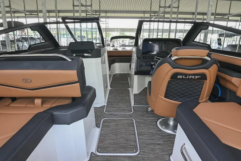 Slide: The Image of Interior of 2022 Cobalt R6 Surf boat with luxurious seating and modern dashboard. - 22