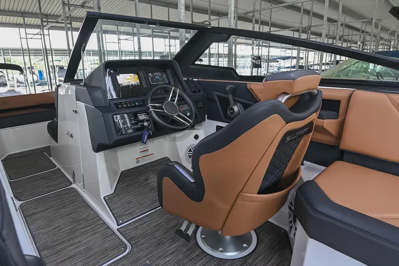 Slide: The Image of Interior of 2022 Cobalt R6 Surf boat with modern dashboard and leather seating. - 23