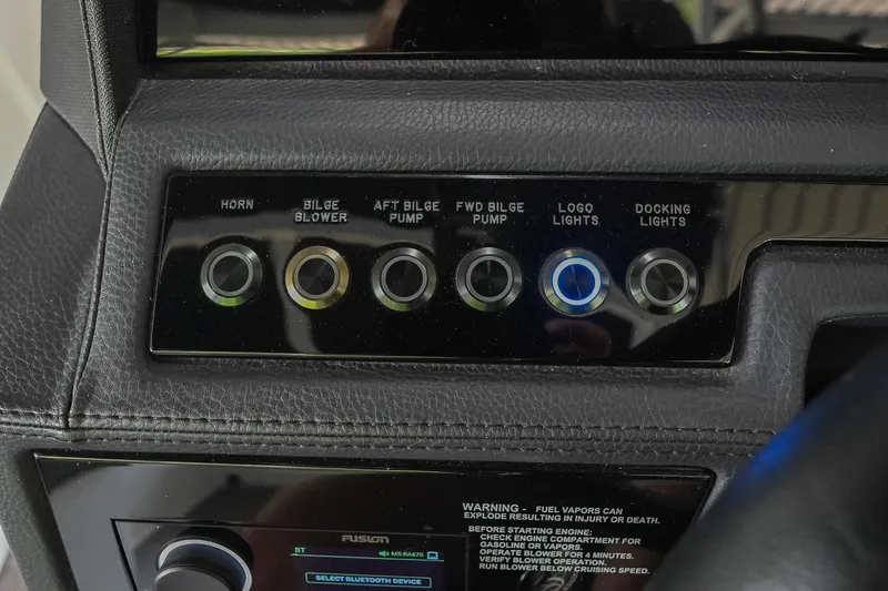 Slide: The Image of Control panel of a 2022 Cobalt R6 Surf boat with labeled buttons. - 27