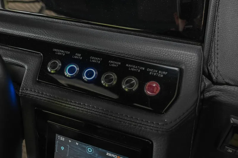 Slide: The Image of Control panel of 2022 Cobalt R6 Surf boat with various light switches. - 29