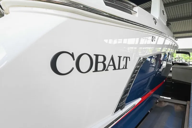 Slide: The Image of 2022 Cobalt R6 Surf boat, sleek design with blue and red accents. - 3