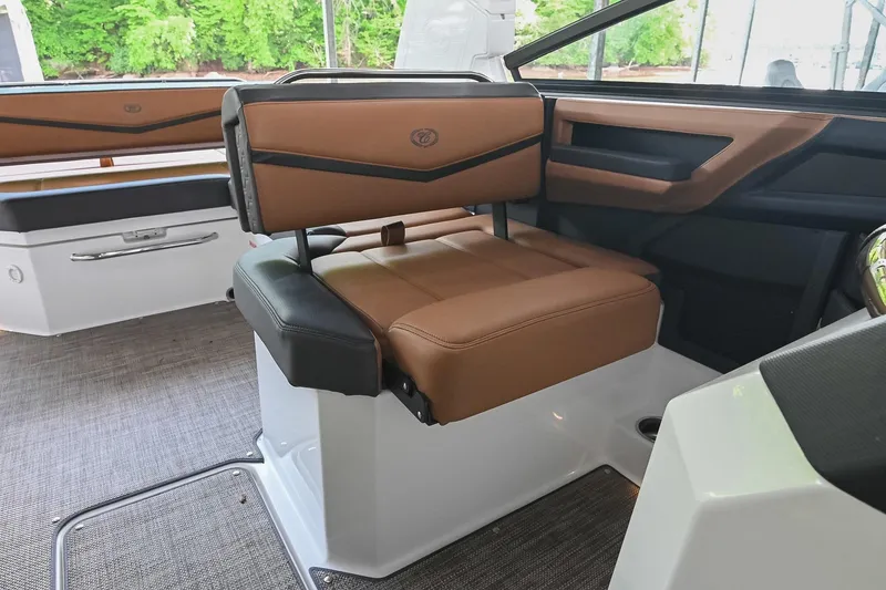 Slide: The Image of 2022 Cobalt R6 Surf boat interior with brown leather seating and modern design. - 36