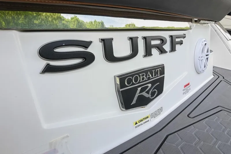 Slide: The Image of 2022 Cobalt R6 Surf boat rear view with logo and caution label. - 4