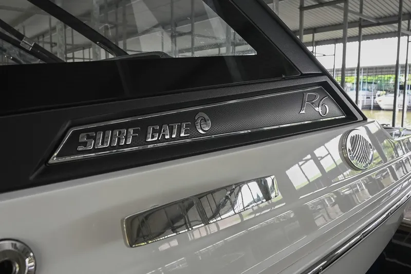 Slide: The Image of 2022 Cobalt R6 Surf boat with Surf Gate feature in a marina setting. - 5