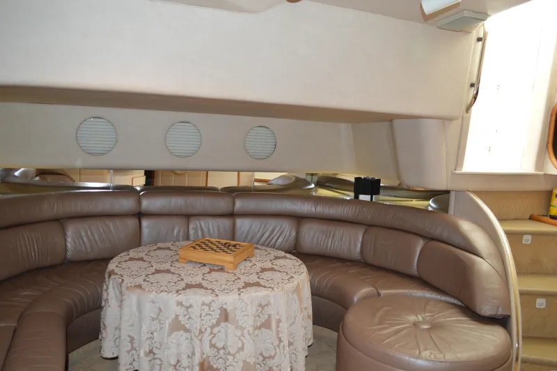 Slide: The Image of 1994 Sea Ray 500 Sundancer interior with leather seating and table. - 11
