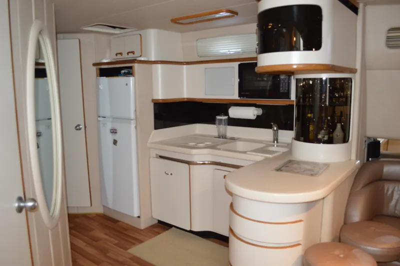Slide: The Image of Interior of 1994 Sea Ray 500 Sundancer yacht featuring modern kitchen. - 16