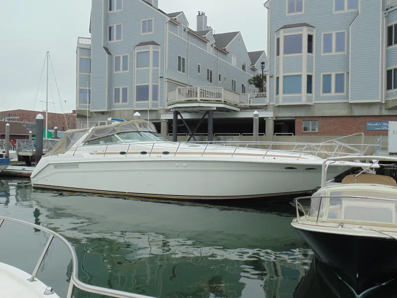 Slide: The Image of 1994 Sea Ray 500 Sundancer yacht docked near modern buildings. - 36