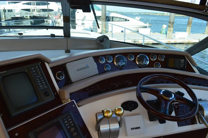 Slide: The Image of 1994 Sea Ray 500 Sundancer cockpit with steering wheel and instruments. - 8