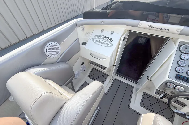 Slide: The Image of Interior of a 2002 Active Thunder 37 boat, featuring seating and control panel. - 10