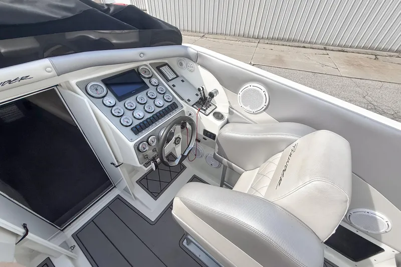Slide: The Image of Cockpit of 2002 Active Thunder 37 boat with steering wheel and control panel. - 11