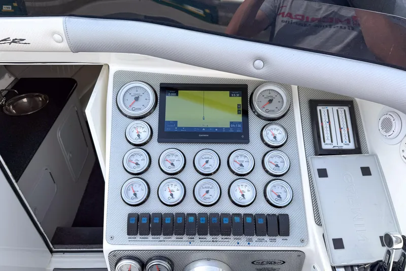 Slide: The Image of Control panel of a 2002 Active Thunder 37 boat with gauges and navigation screen. - 12