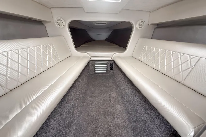 Slide: The Image of Interior cabin of a 2002 Active Thunder 37 boat with cushioned seating. - 16