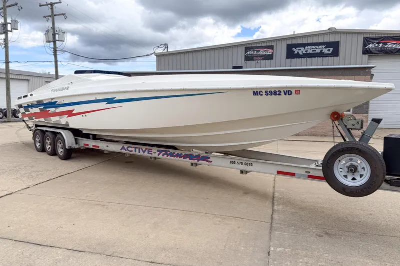 Slide: The Image of 2002 Active Thunder 37 boat on trailer, featuring dynamic graphics and sleek design. - 19