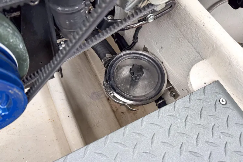 Slide: The Image of Engine compartment of a 2002 Active Thunder 37 boat, showing mechanical components and a filter. - 24