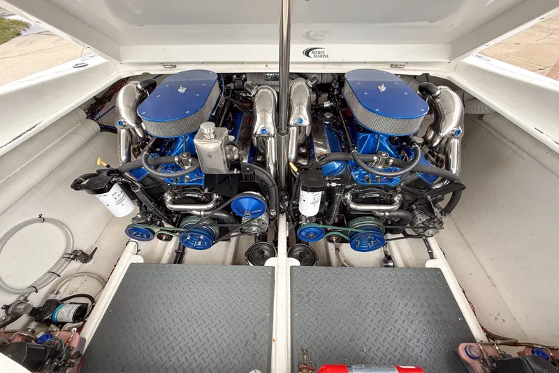 Slide: The Image of Engine compartment of a 2002 Active Thunder 37 boat, featuring dual blue engines. - 25