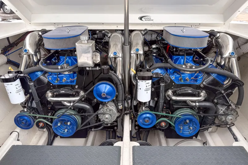Slide: The Image of Twin engines of a 2002 Active Thunder 37 boat, showcasing polished components and blue accents. - 27