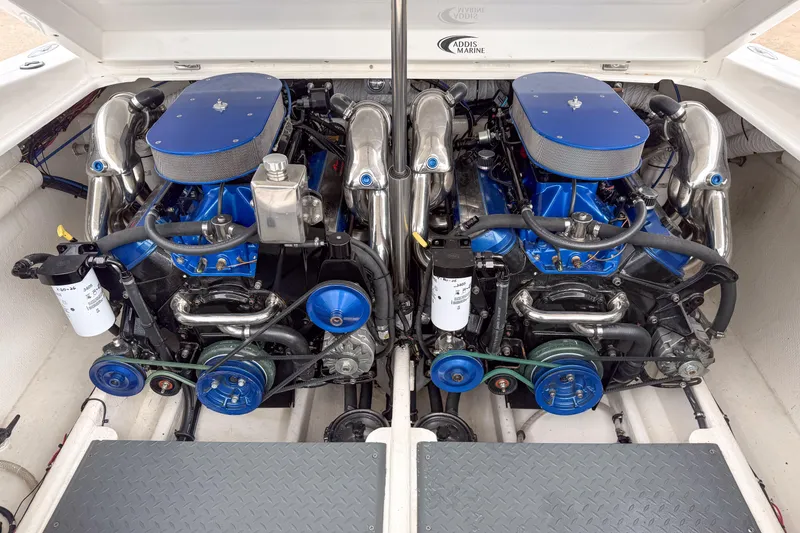 Slide: The Image of Twin engines in a 2002 Active Thunder 37 boat, showcasing blue and chrome components. - 28