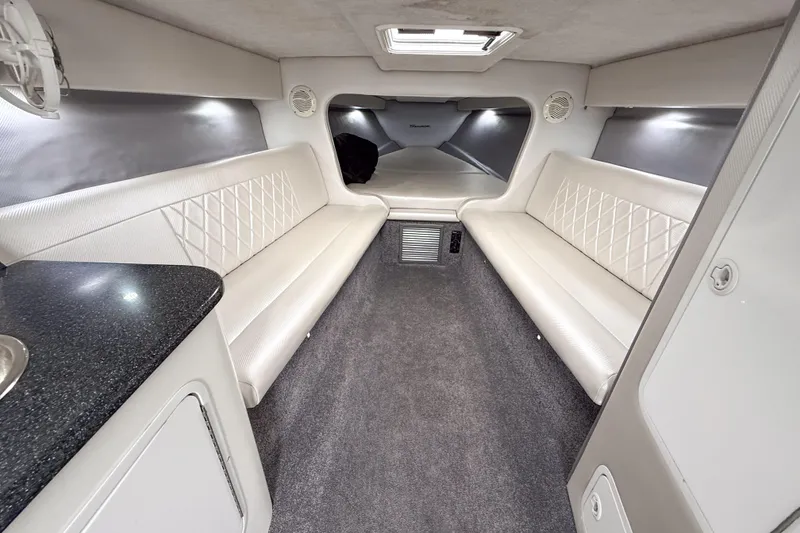 Slide: The Image of Interior of a 2002 Active Thunder 37 boat with white seating and modern design. - 36