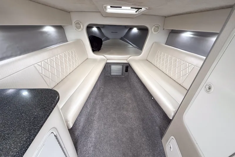Slide: The Image of Luxurious interior of a 2002 Active Thunder 37 boat with white seating and modern design. - 39