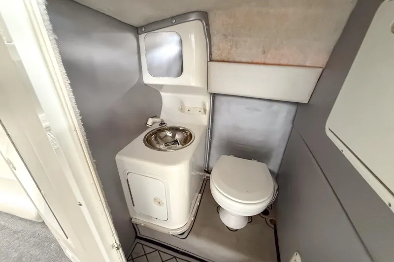Slide: The Image of Compact bathroom in a 2002 Active Thunder 37 boat, featuring a toilet and sink. - 40