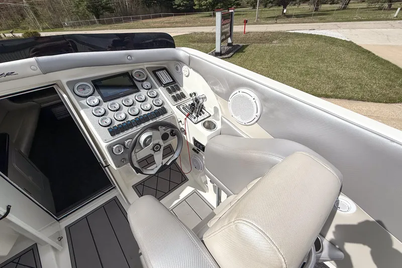 Slide: The Image of Cockpit of 2002 Active Thunder 37 boat with steering wheel and control panel. - 44