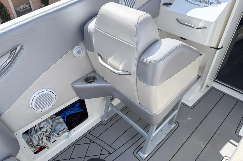 Slide: The Image of Interior of a 2002 Active Thunder 37 boat featuring a cushioned seat and storage compartment. - 47