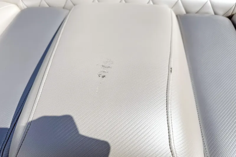 Slide: The Image of White leather seat with slight wear on a 2002 Active Thunder 37 boat. - 48