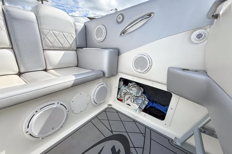 Slide: The Image of Interior of a 2002 Active Thunder 37 boat with cushioned seating and storage compartment. - 50