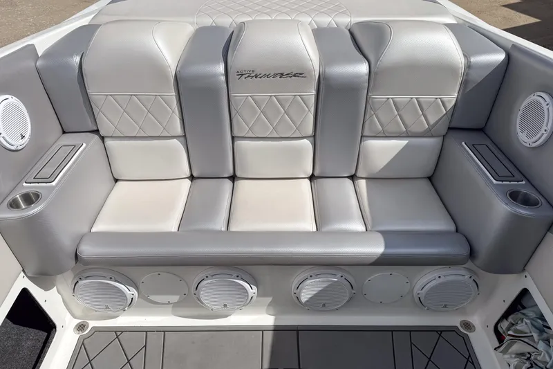 Slide: The Image of Luxurious seating in a 2002 Active Thunder 37 boat, featuring premium upholstery and integrated speakers. - 53