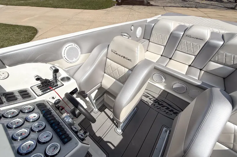 Slide: The Image of Interior of a 2002 Active Thunder 37 boat with luxurious seating and control panel. - 55
