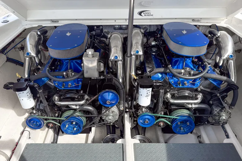Slide: The Image of Twin engines in a 2002 Active Thunder 37 boat, featuring blue accents and chrome details. - 6