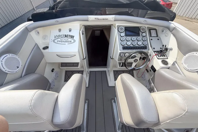 Slide: The Image of Interior view of a 2002 Active Thunder 37 boat cockpit with steering wheel and control panel. - 9