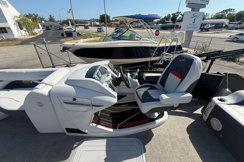 Slide: The Image of 2022 Barletta Corsa 23U boat interior with modern helm and seating. - 10