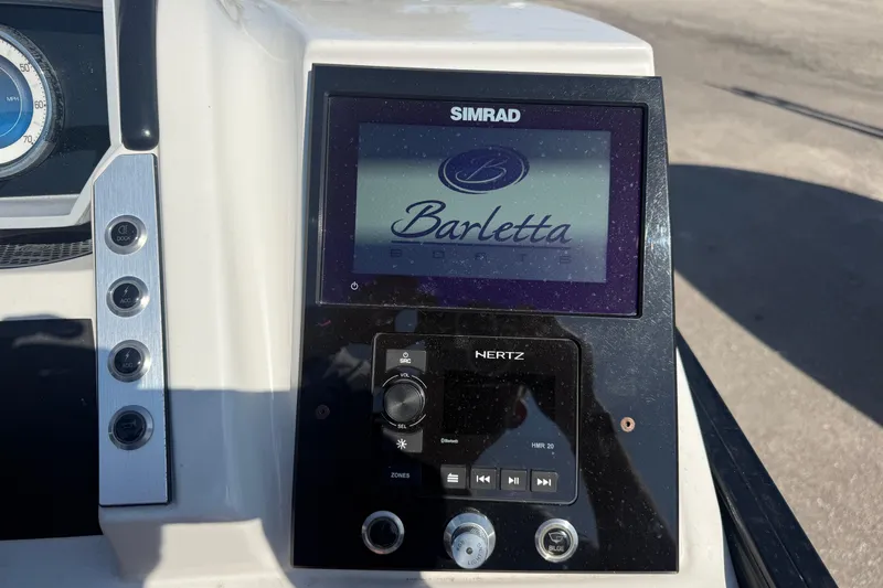 Slide: The Image of Dashboard of 2022 Barletta Corsa 23U with Simrad display and Hertz controls. - 12