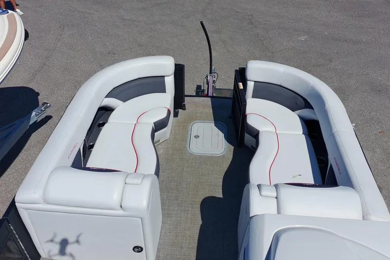 Slide: The Image of 2022 Barletta Corsa 23U pontoon boat interior with curved seating and gray flooring. - 14